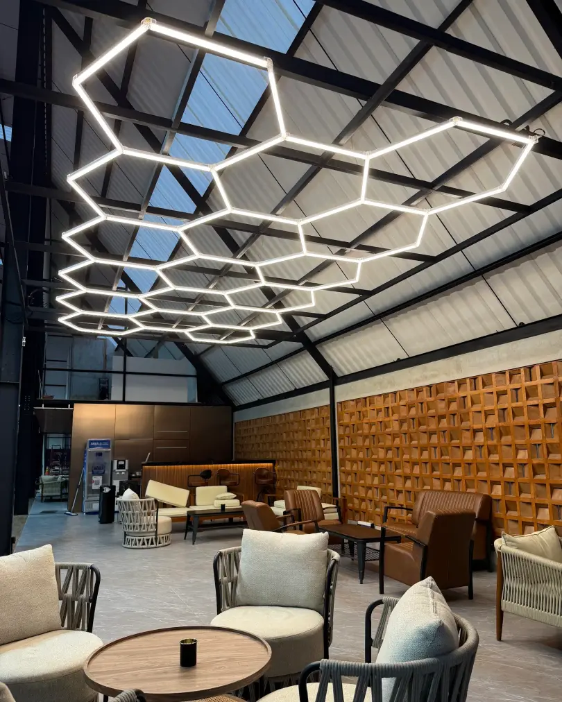 Lounge under the hexagon lights with timber wall