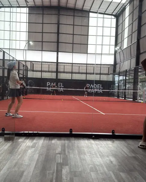 Player on a terracotta court with Padel Mafia branding