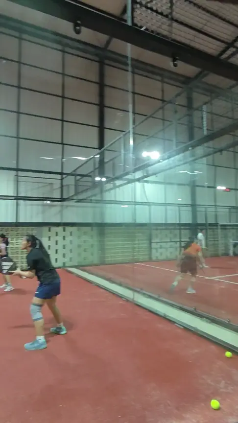 Players in a rally behind the glass